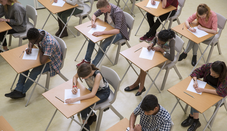 group of students writing on a bond paper