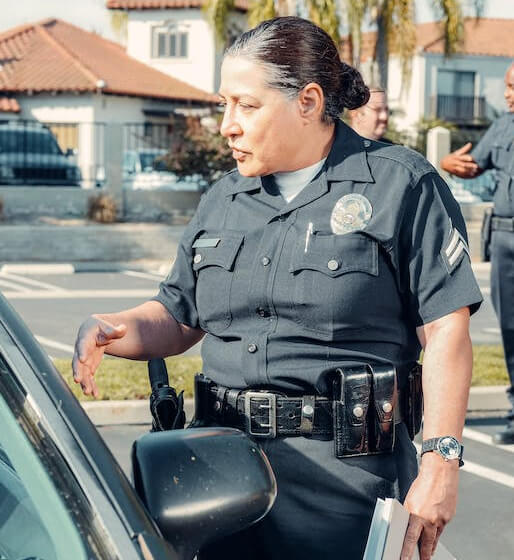 police woman talking on a window side of a car