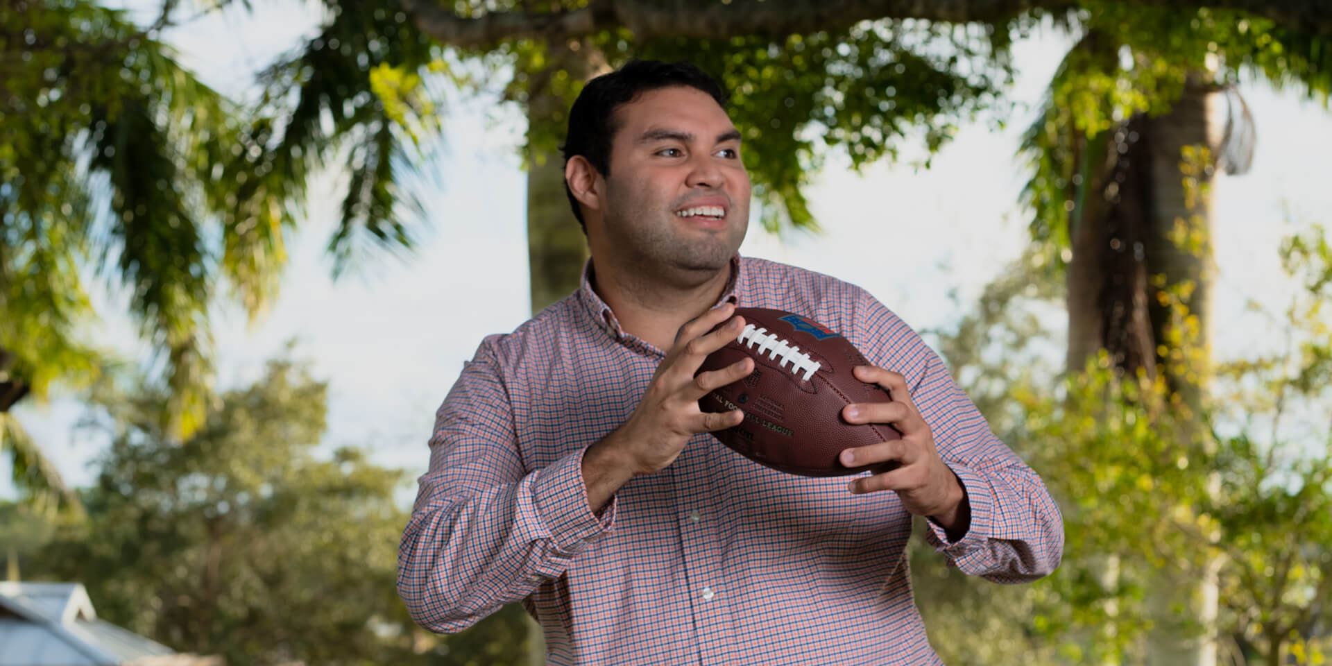 Steve Avila holding an American football ball